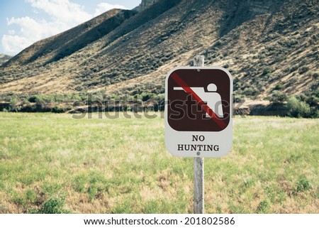 No Hunting Sign with graphic on Public Land in the  Painted Hills. The Painted Hills Unit is located in John Day Fossil Beds National Monument in eastern Oregon.