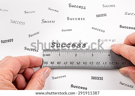 A man measures the word Success with a ruler