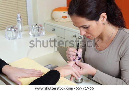 Fingernails manicure. Pro at work with her client.