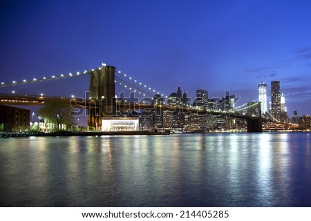 Brooklyn Bridge reflects off the water at night