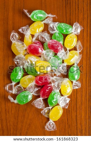 Pile of color candies on a brown table