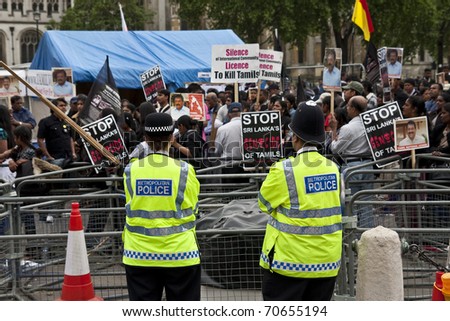 LONDON - MAY 25: Police watch over a demonstration at Parliament Square by protesters against the Sri Lankan government\'s treatment of Tamils on May 25, 2009 in London.