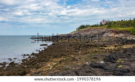 Point Prim Lighthouse as seen from the rocky beach below during low tide. Located near Digby, Nova Scotia. Stock foto © 