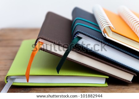 notebook stack on wood background