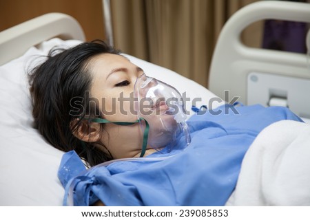 Mom in mask oxygen after childbirth