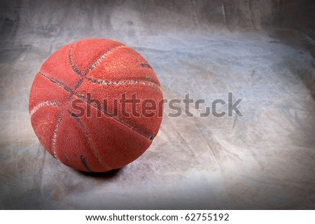 Vintage basketball on brown back drop with copy space ball is very cracked and aged with texture