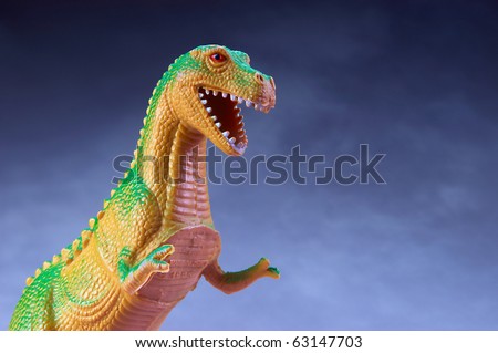 Toy Dinosaur with copy space and blue background