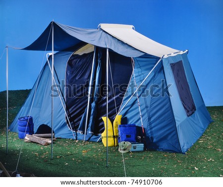Large tent on grass and blue background camping outdoors