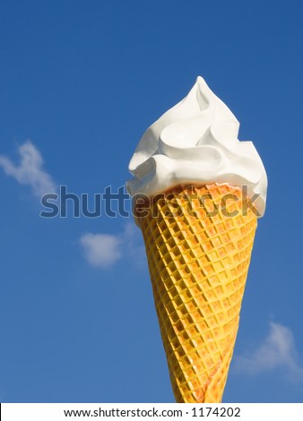 Giant ice cream cone over a clear blue sky at a fun fair