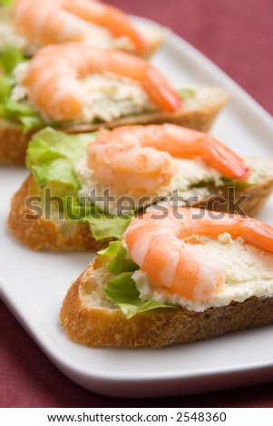 Closeup view of shrimp toasts with salad and garlic cheese (shallow DOF)