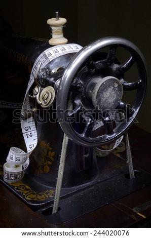 Retro sewing machine from pulley side and tape measure
