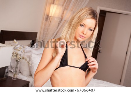 Sexy blond woman in black bikini top