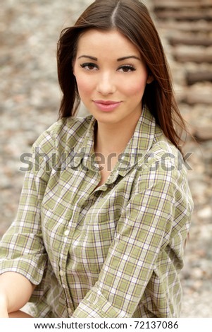 Close up Portrait of young woman kneeling down outdoors