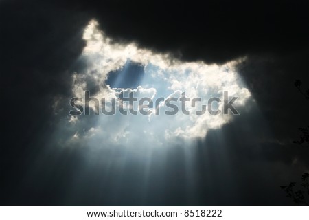 Rays of light shining throug dark clouds