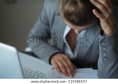 Closeup on stressed business woman working with documents