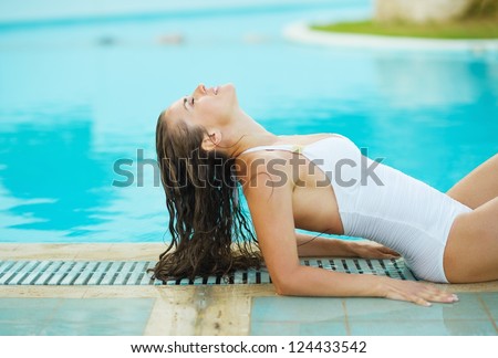 Young woman relaxing in poolside
