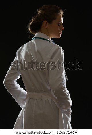 Silhouette of medical doctor woman looking on copy space