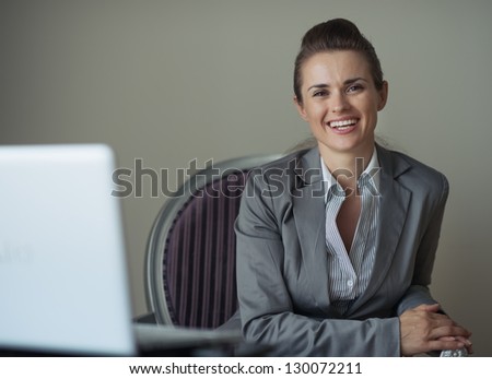 Portrait of smiling business woman in hotel room
