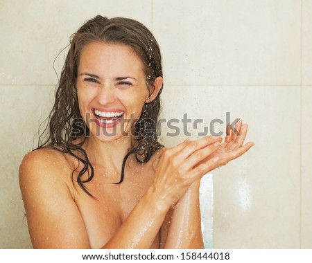 Portrait of smiling young woman taking shower