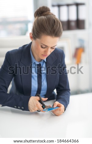 Business woman cutting credit card with scissors