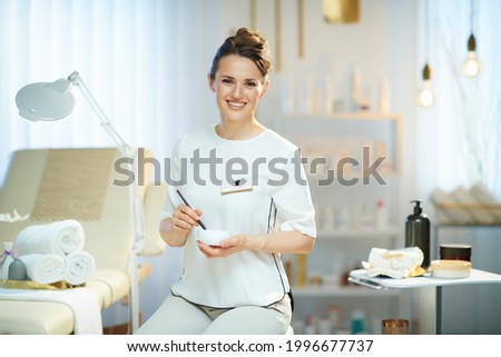 happy female employee in modern beauty salon working. Foto d'archivio © 