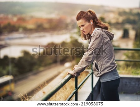 Fitness young woman looking into distance outdoors