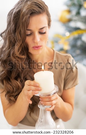 Portrait of young woman blowing candle