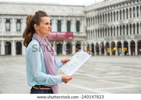 Young woman with map on piazza san marco in venice, italy