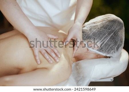 Similar – Image, Stock Photo Therapist doing loin massage for patient in clinic