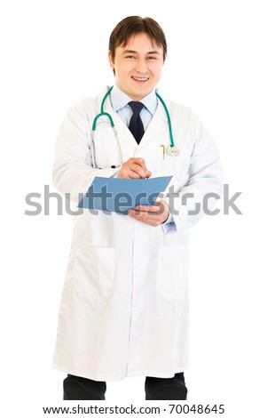 Smiling medical doctor writing report in medical chart of patient isolated on white