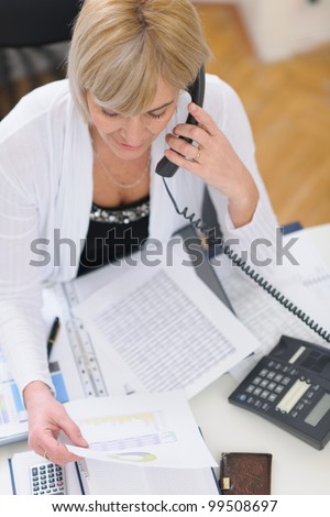 Senior business woman making phone call. Top view