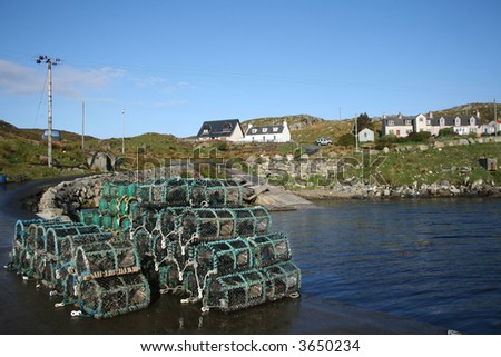 lobster pots stacked in piles beside sea shore