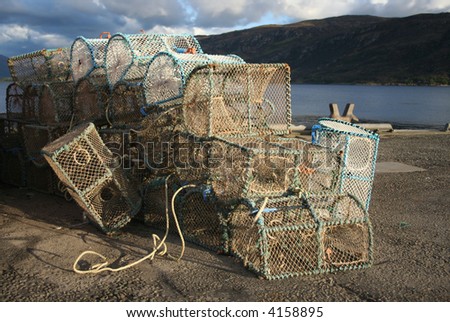 lobster pots stacked in piles beside sea shore