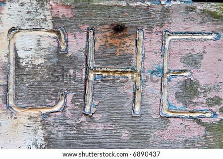 Three letters carved on a decrepit painted board : che... for ?