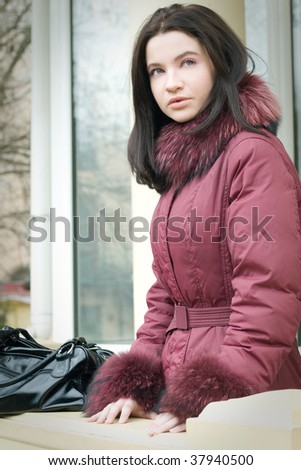 beautiful girl in purple fur coat outdoors