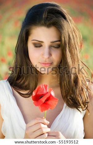 young sensual girl with poppy in the field