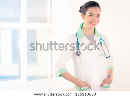 Portrait of a beautiful happy female doctor in the hospital