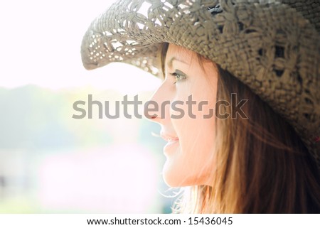 profile of beautiful smiling girl in hat