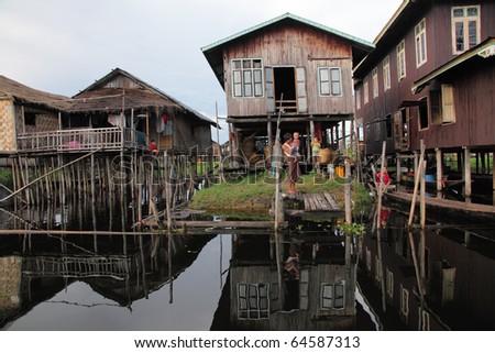 MYANMAR-OCTOBER -15: People live at wooden stilt houses  in the water on October 15, 2010 Inle lake Myanmar. Inle lake the favorite attractions for tourists who like the traditional view of life.