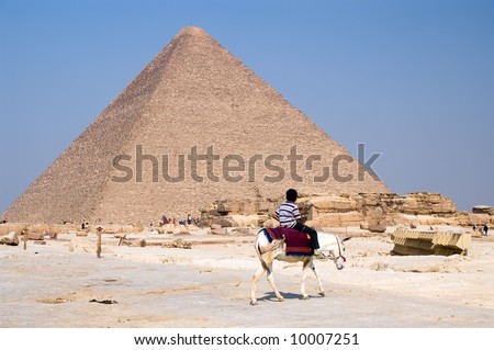 Great Pyramid of Giza (pharaoh Khufu pyramid) and arab boy on donkey, Cairo, Egypt