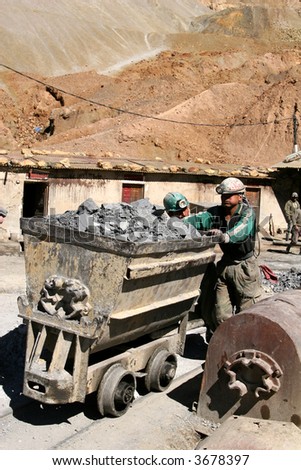 Miner pushing mine cart
