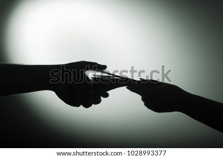 Similar – Image, Stock Photo Two shadows hands in red and green light circle.