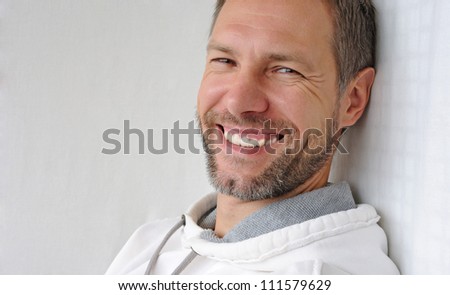 Portrait of smiling man in white