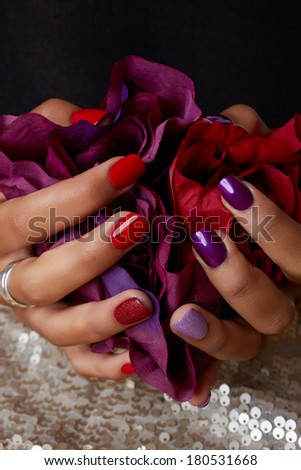 Woman Hands Holding Red Silk Rose. Pastel pink and purple manicure. Isolated On White Background