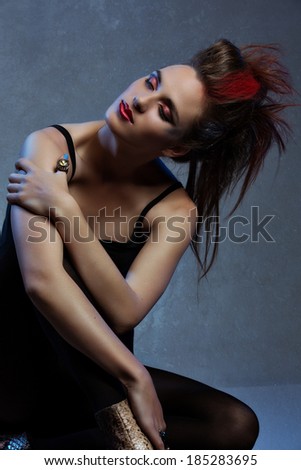 Young Model with bright punk fashion make-up and rocker hairstyle