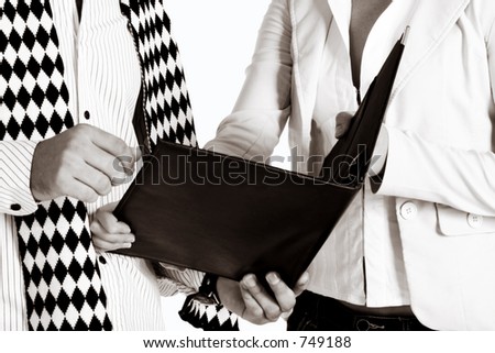 businesswoman and her partner with a black leather folder, soft sepia finish