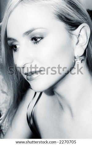 Face of a woman with long fair hair and big eyes - shot from the side