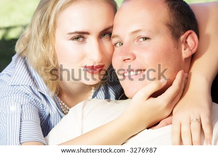 Young married couple, faces touching, man smiling. Very casual. ISO 100, no sharpening