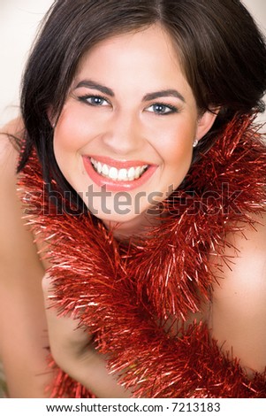 Beautiful woman with long brown hair, blue eyes with red shiny tinsel