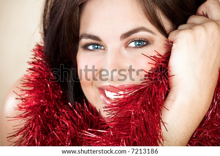 Beautiful woman with long brown hair, blue eyes and red tinsel
